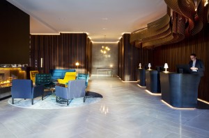 Crowne Plaza Christchurch lobby welcomes with plush seating and central fireplace. Photo credit-Designworks